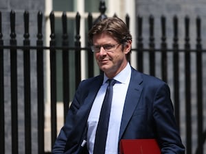 Greg Clark walks along Downing Street