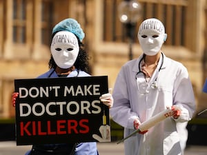 Campaigners protest outside Parliament in Westminster,