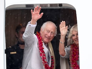 The King and Queen Camilla waving