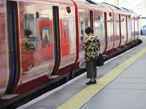 Passenger standing on a platform next to a South Western train