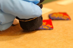 Volunteer Eve vacuums a cloth badge with boxer shorts!  