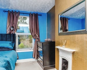 Who wouldn't want a bright blue and gold bedroom? 