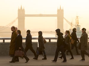 People walking across a London bridge