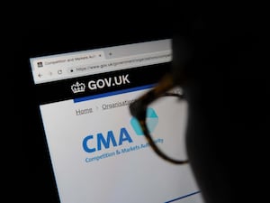 A person looks at the Competition and Markets Authority website