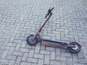 Electric scooter on a background of a wall