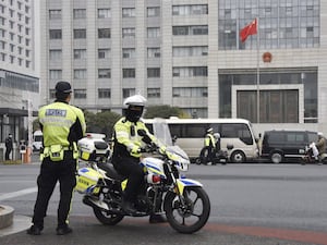 Police officers patrol at the Jiangsu Suzhou Intermediate People’s Court in Suzhou, China