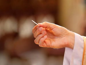 A priest gives holy communion