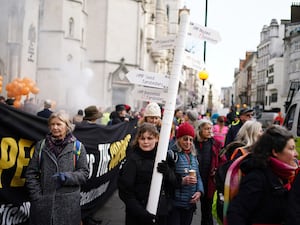 Campaigners outside the Royal Courts of Justice on the first day of appeals against sentences of 16 climate activists jailed for protests (Jordan Pettitt/PA)