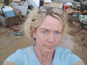 A woman in front of mud