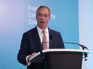 Nigel Farage speaks at a podium