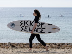 A woman with a surfboard