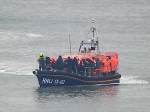 The Dungeness Lifeboat brings a group of people into Dover.