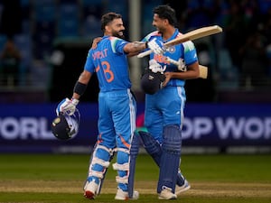 Virat Kohli, left, celebrates India's win with Axar Patel