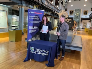 Two people manning a Crimestoppers table at the Hunterian Museum