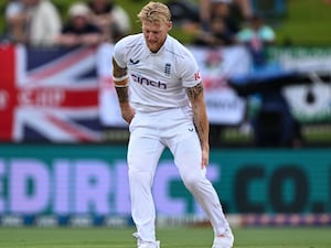 Ben Stokes clutches his hamstring