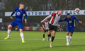 Hednesford's Ollie Harrison (centre) against Chasetown. Picture: Jim Wall. 