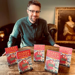 Jim Spencer with rare hardback and paperback first editions of Harry Potter and the Philosopher's Stone