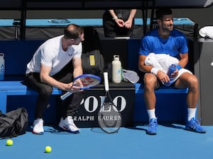 Andy Murray, left, talks with Novak Djokovic during a practice session