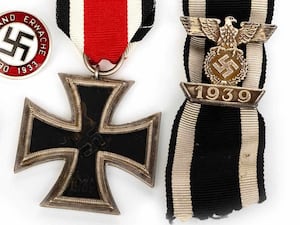 A German Iron Cross, ribbon and Nazi badge