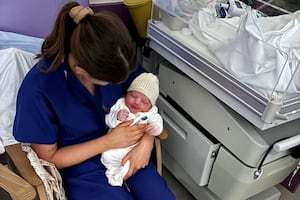 The first new year  baby born at New Cross Hospital with midwife, Amira Purcell