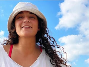 Handout photo of Emily Damari smiling, under blue skies