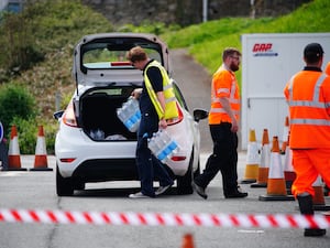 People collecting bottled water in Brixham, Devon, earlier this year