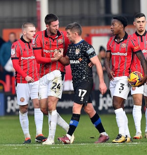 Sam Finley makes his way off the pitch after getting a red.