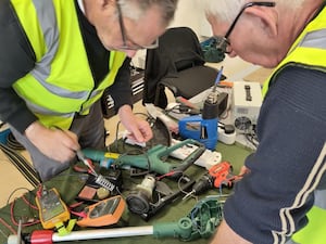 Volunteers fixing an electrical item