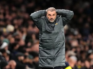 Tottenham boss Ange Postecoglou holds his head as he reacts