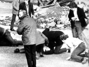 A man receiving attention during the Bloody Sunday shooting incident