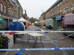 Police at the scene in East Street, Walworth, south London, following a fatal stabbing