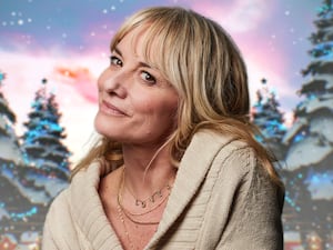 Tamzin Outhwaite smiles in front of a snowy Christmas-themed background