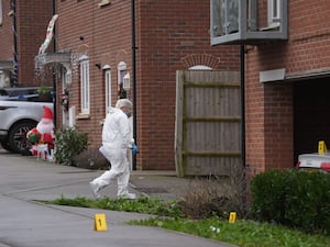 A police forensic officer at the scene near an apartment block on Santa Cruz Avenue in Newton Leys, near Bletchley, Buckinghamshire