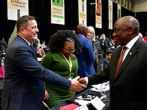 South African President Cyril Ramaphosa, right, greeting opposition Democratic Alliance leader John Steenhuisen