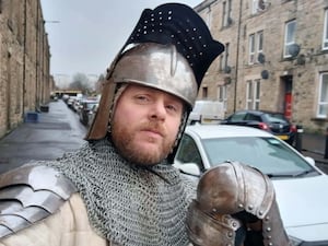 Callum Maclean on a street in full armour