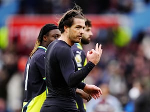 Manchester City’s Jack Grealish gestures the number three to the crowd