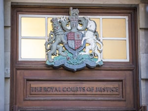 Crest of the Royal Courts of Justice above an entrance