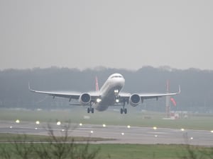 A plane takes off from Gatwick Airport in foggy conditions