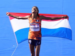 Sifan Hassan holding up the Netherlands flag