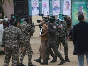 Eli Sharabi is escorted by Hamas fighters