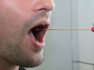 A man giving a saliva swab