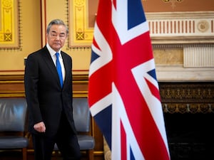 China’s foreign affairs minister Wang Yi walks past a Union Jack