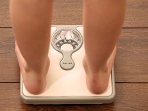 A person standing on a set of scales from knee down