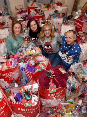 Caroline Wootton, Tracey Hale, Karen Train and Darren Train with just some of the Christmas hampers they have put together for local schools.