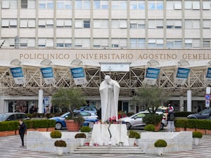 A statue of Pope John Paul II is seen in front of the Agostino Gemelli Polyclinic, in Rome