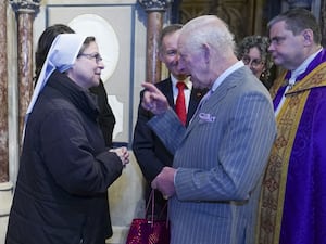 The King meets Sister Annie Demerjian during an advent service celebrating the strength and courage of faith communities at the Catholic Church of the Immaculate Conception, also known as Farm Street Church, in London