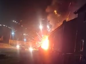 Fireworks going off in a van in a street