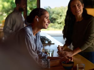 A woman wearing AirPods in a bar