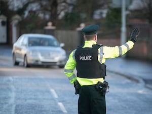 A police officer flags down a car