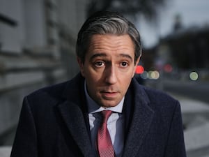 Taoiseach Simon Harris speaking to members of the media outside Government Buildings (PA)